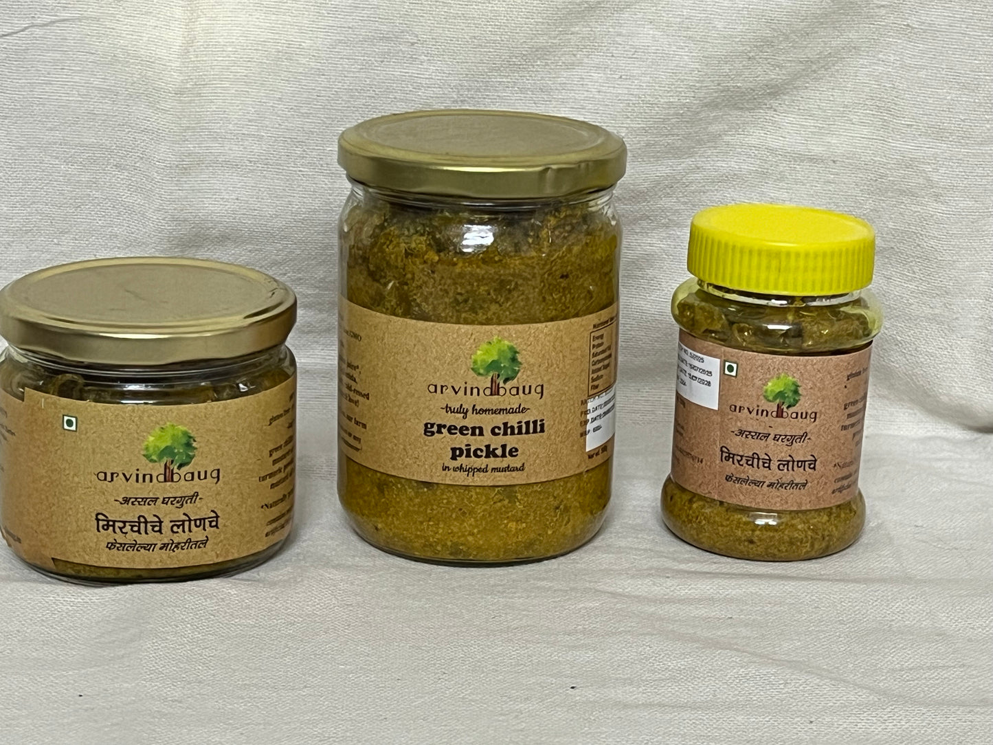 200 g, 250 g, and 500 g jars of Arvindbaug green chilli pickle in whipped mustard.