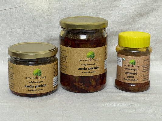 200 g, 250 g, and 500 g jars of Arvinbaug Amla Pickle with whipped mustard.


