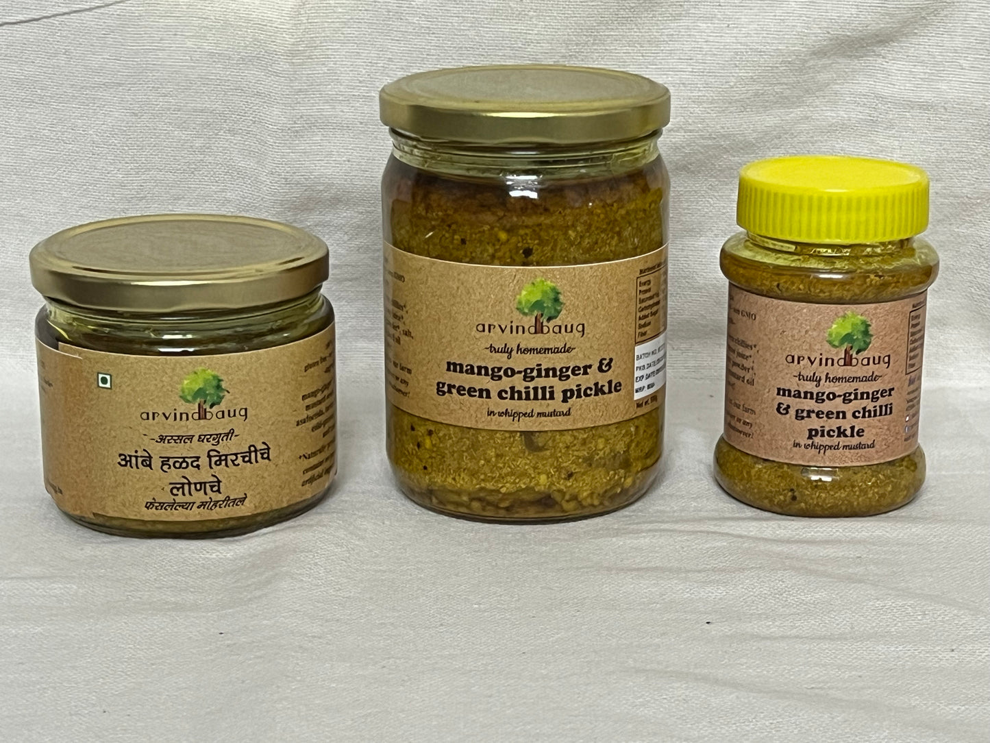 200 g, 250 g, and 500 g jars of Arvindbaug mango-ginger and green chilli pickle in whipped mustard.
