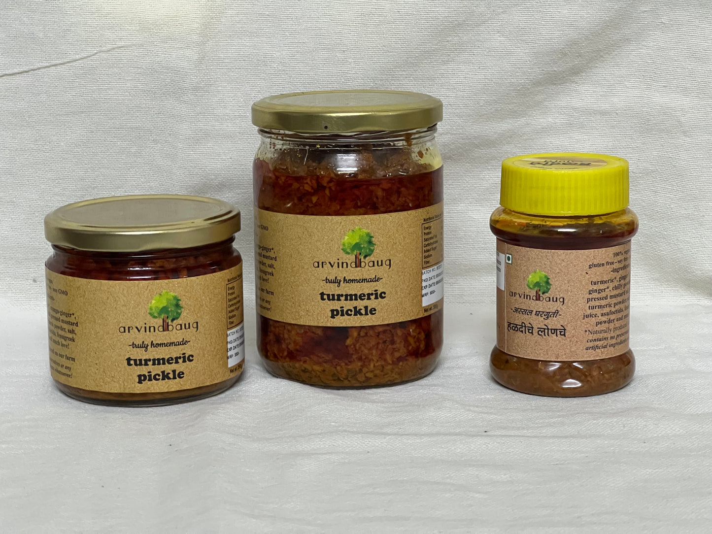 200 g, 250 g, and 500 g jars of Arvindbaug turmeric pickle.